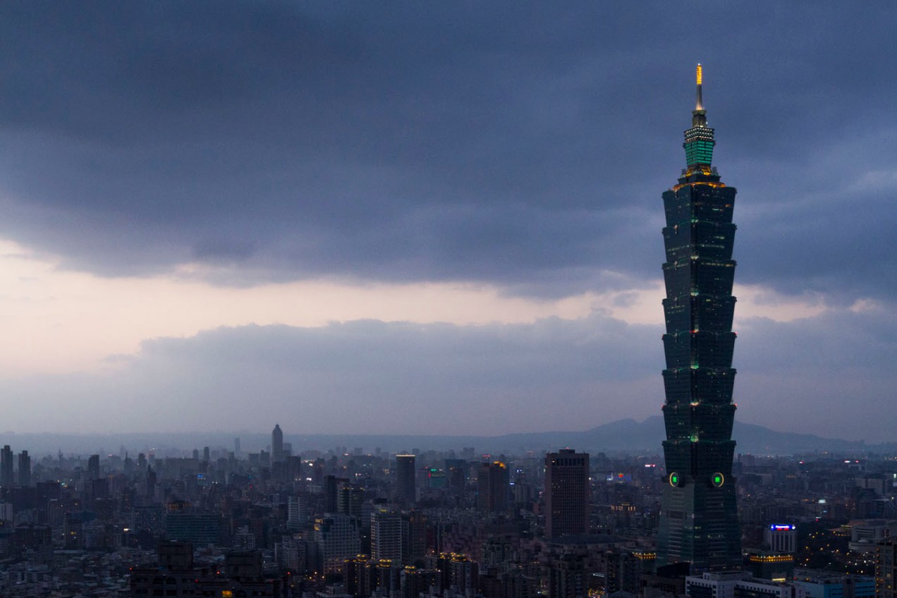 Taipei 101 in the clouded sunset with green lights