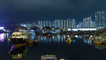 lei yue mun harbor at night with HK in the background
